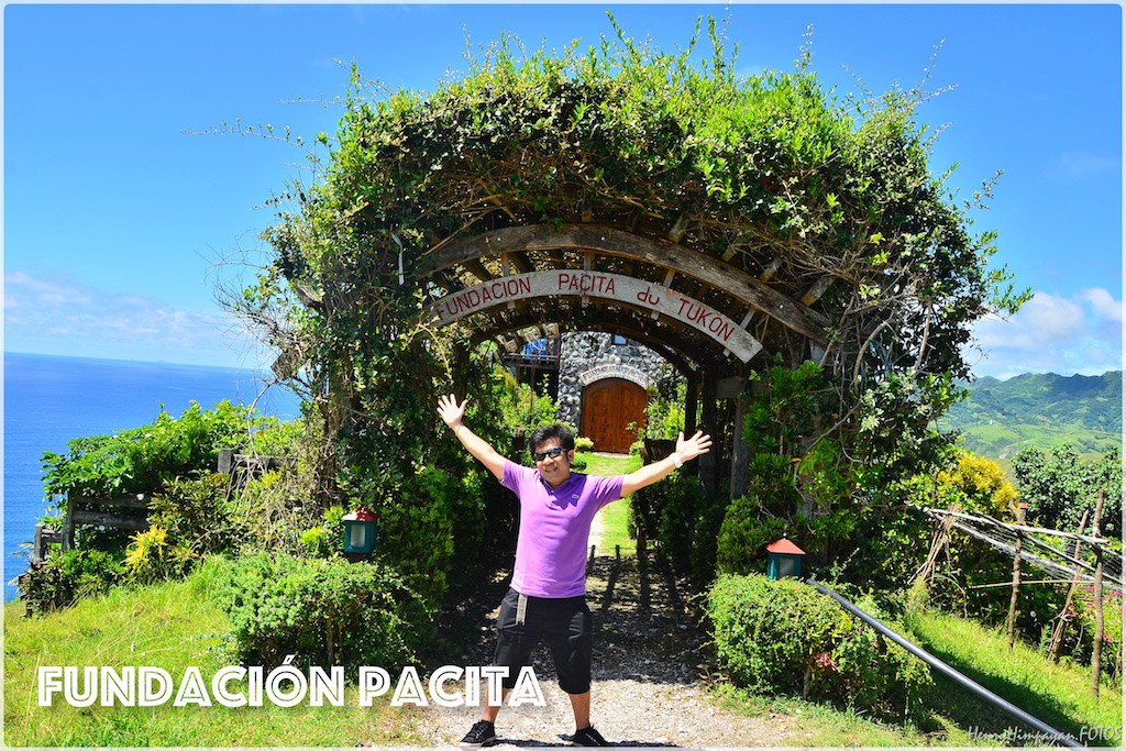 pose at the entrance arch of Fundacion Pacita