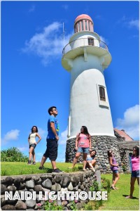 the gang poses with the lighthouse